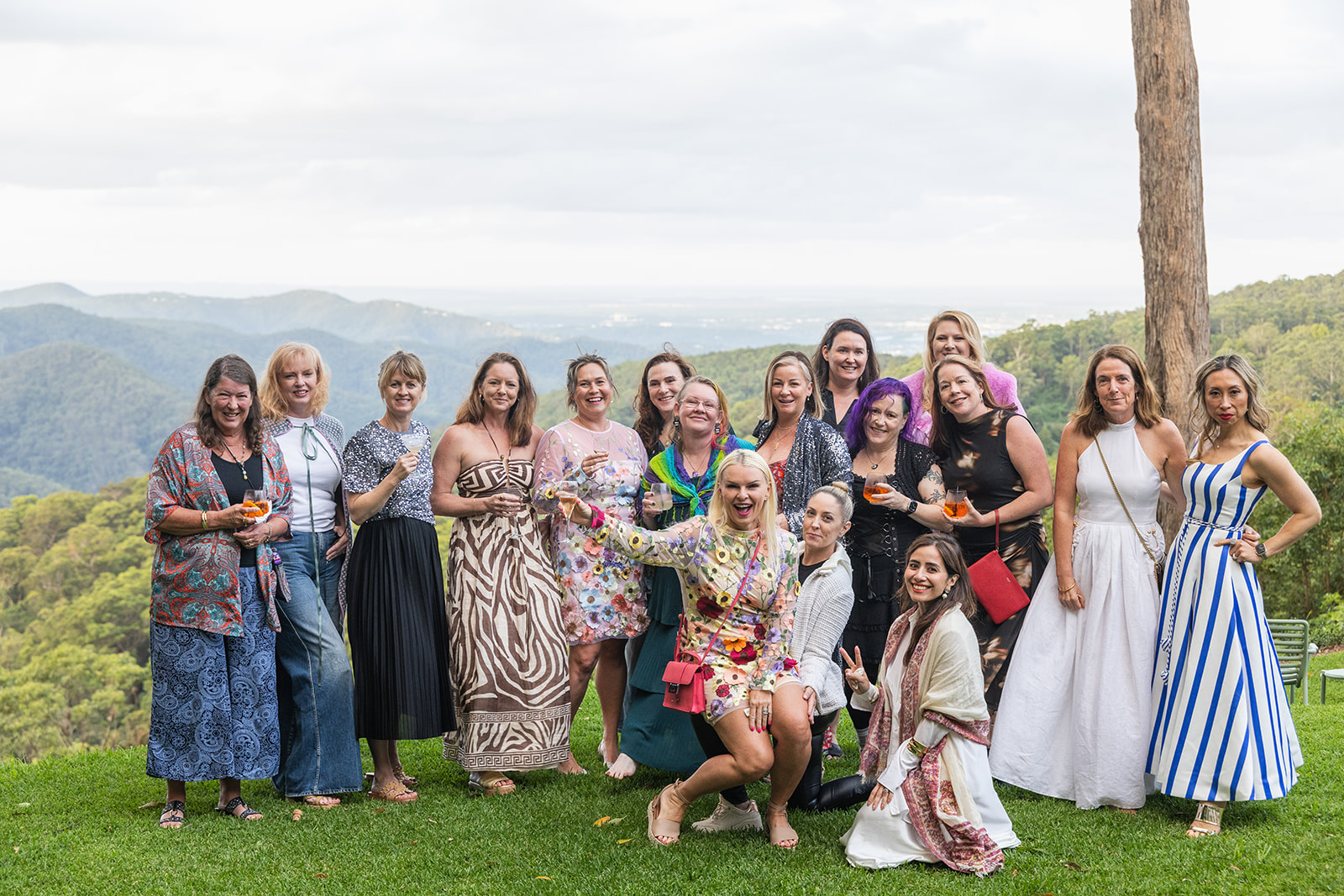 Group portrait of FemPowered Retreat guests on a hilltop lawn overlooking the hinterland