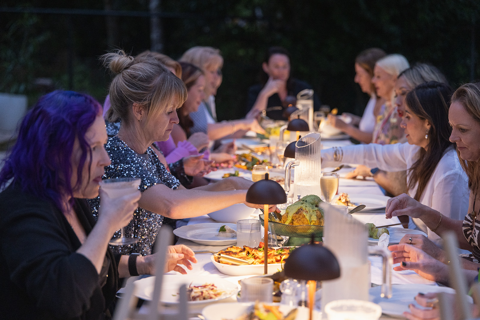 FemPowered retreat guests sharing dinner around a long table