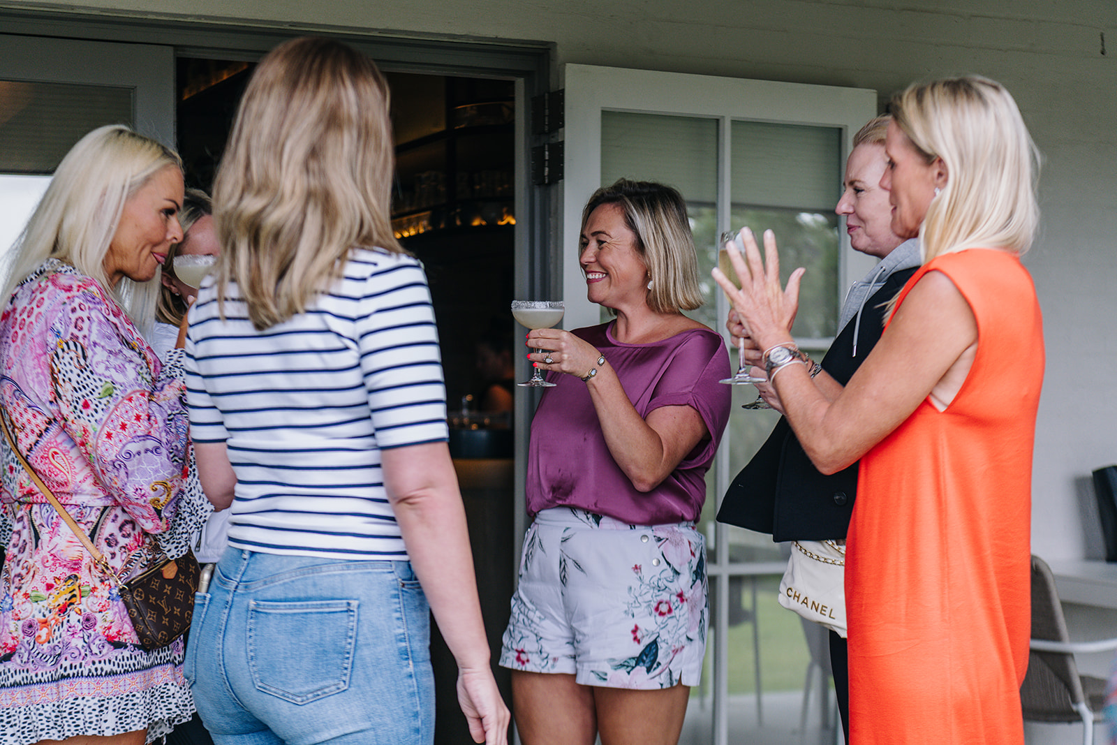 Women in conversation with cocktails at a FemPowered Retreat gathering