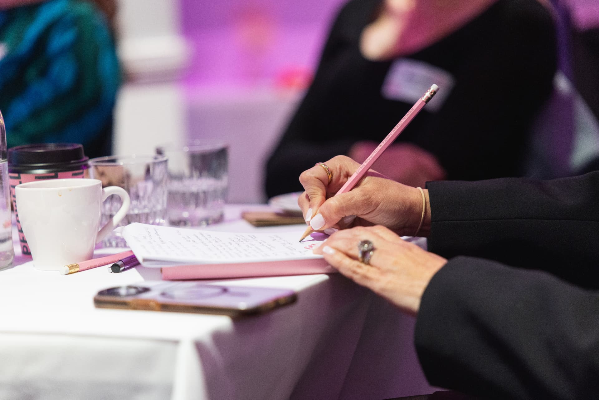 A founder taking notes with a FemPowered pencil during an advisory session