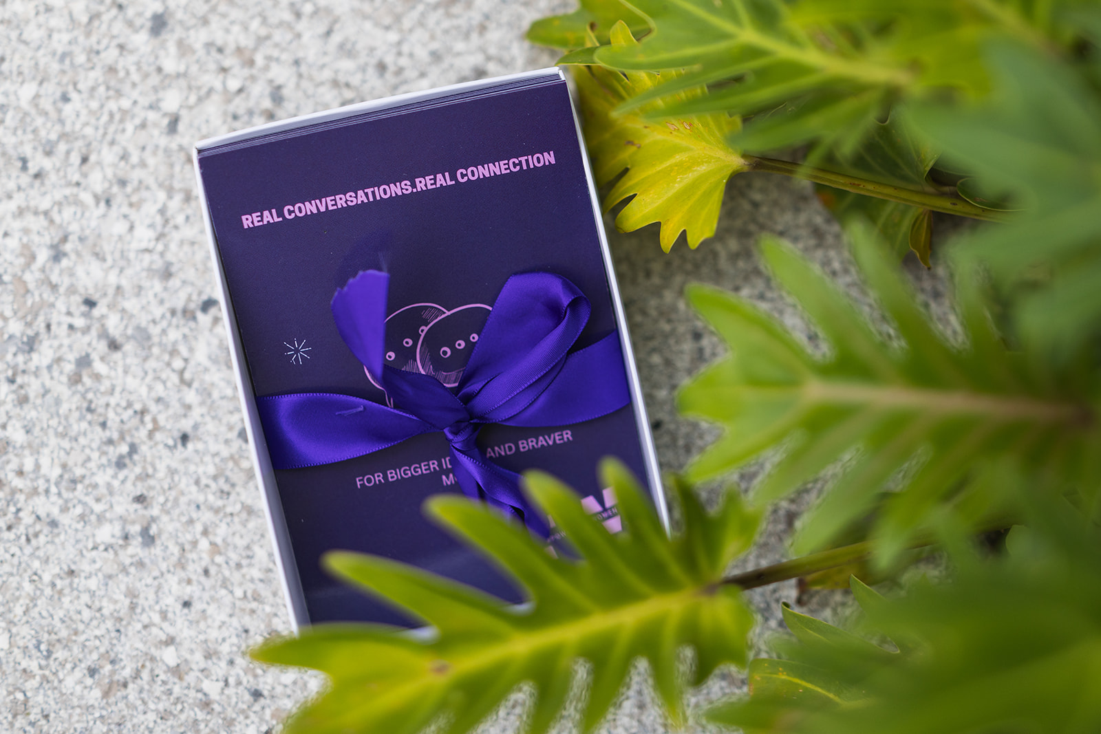 FemPowered welcome gift with purple ribbon and real conversations branding